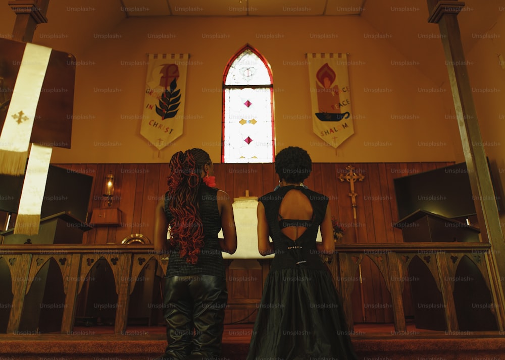 a couple of people that are standing in front of a church