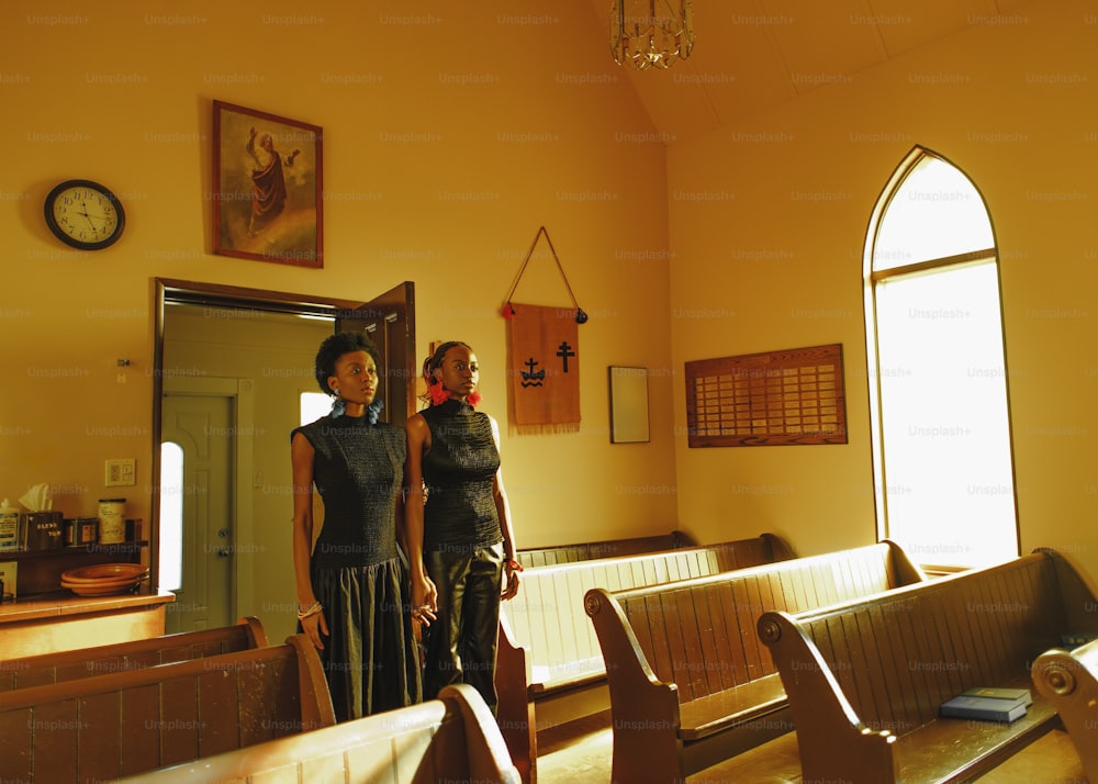 a couple of women standing next to each other in a church