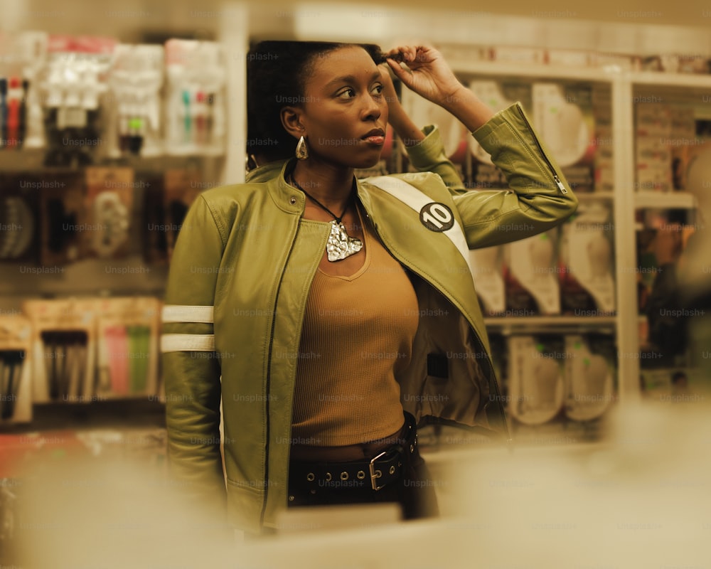 a woman standing in a store looking at the camera