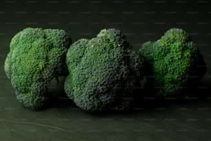 three pieces of broccoli sitting next to each other