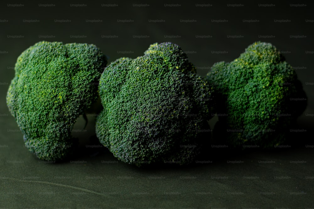 three pieces of broccoli sitting next to each other