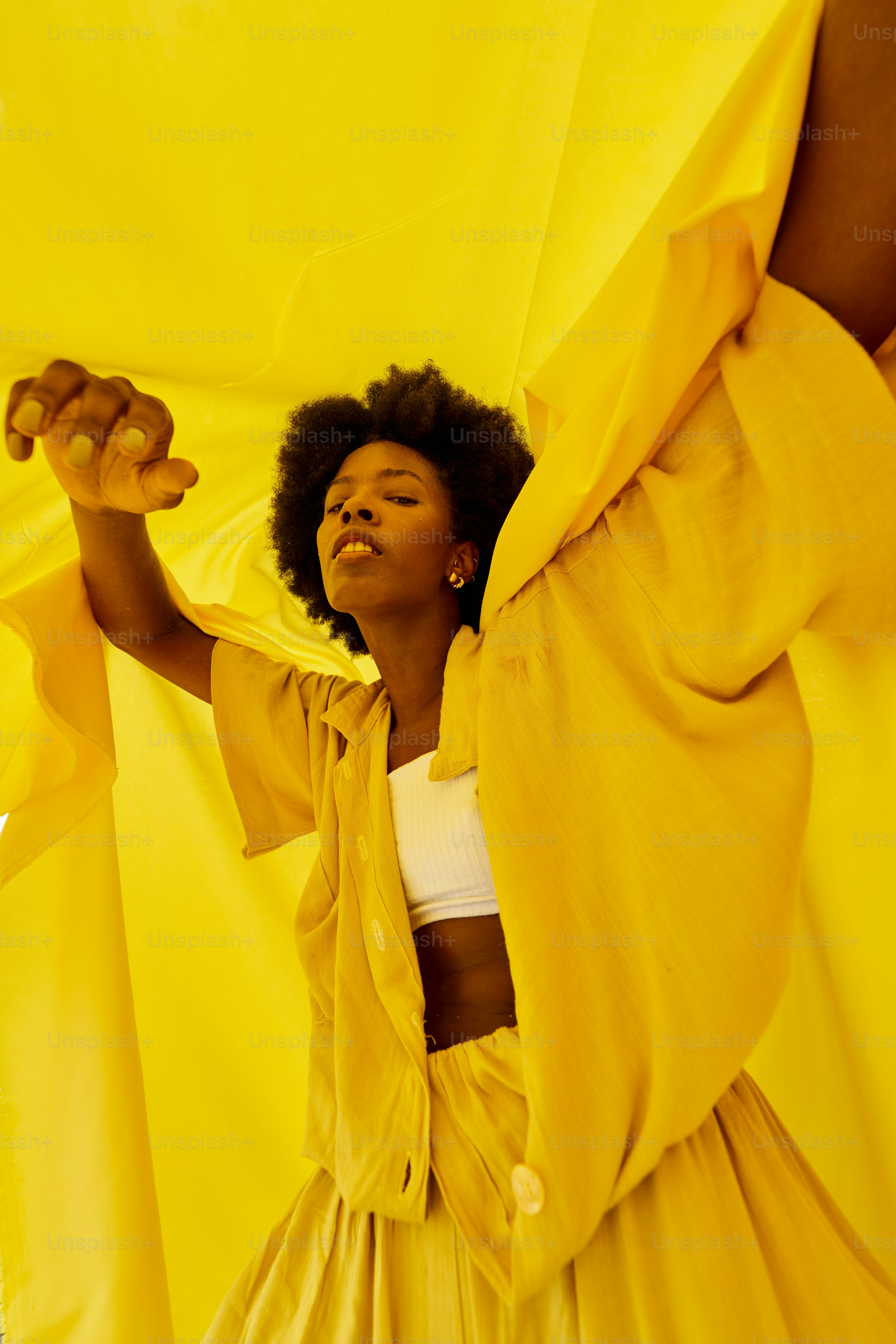 a woman in a yellow dress and a yellow sheet
