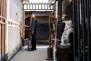 a man standing in an alley between two buildings