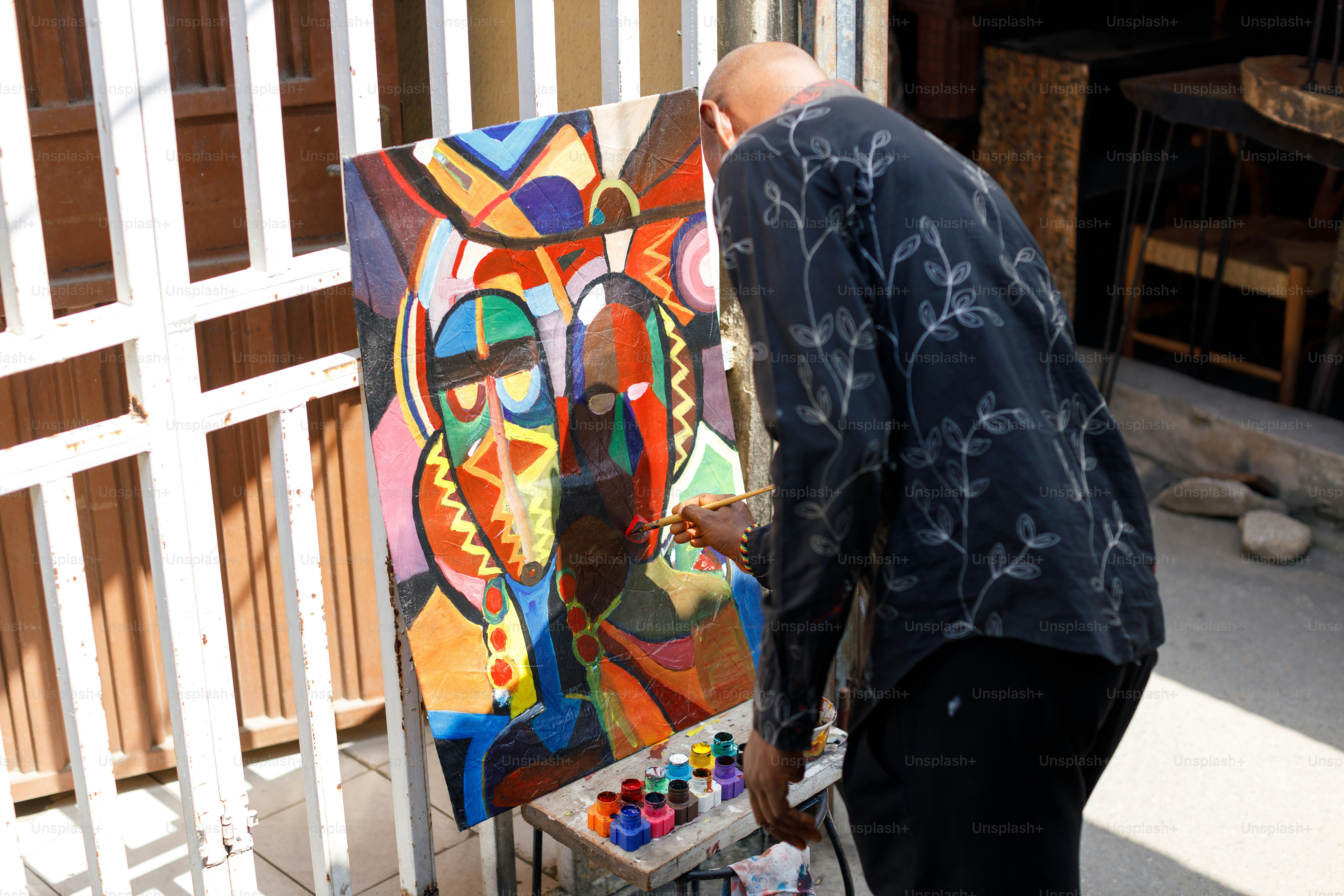 a man is painting a picture on a easel