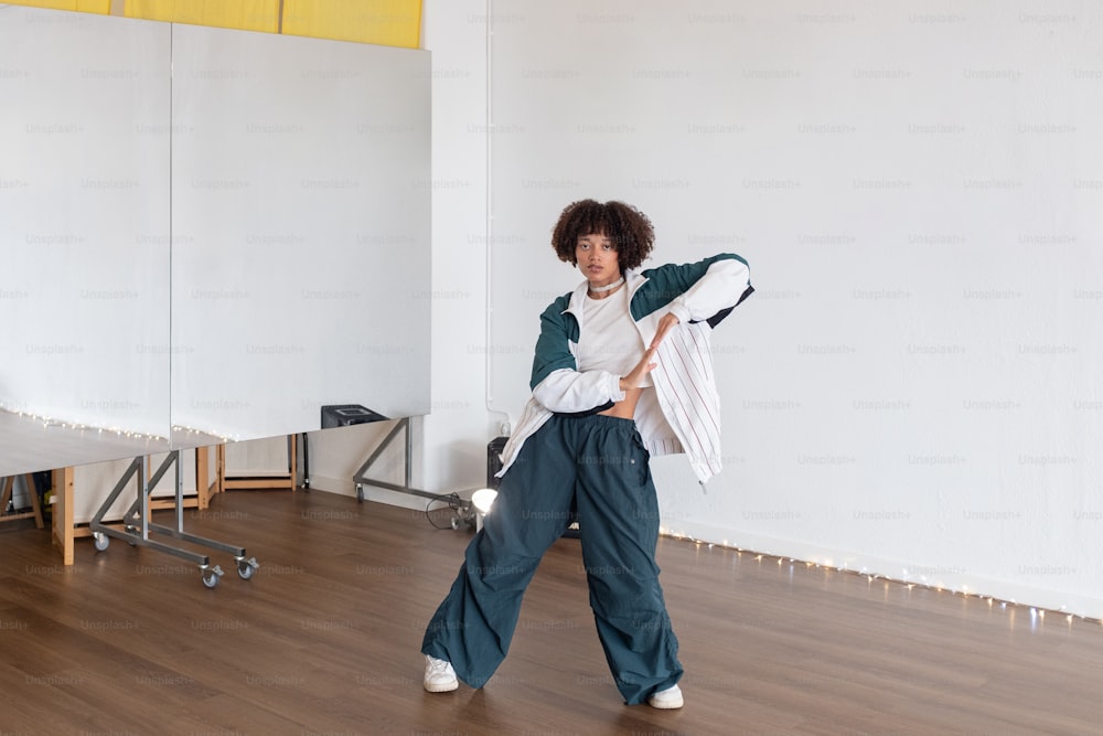 a woman walking across a hard wood floor