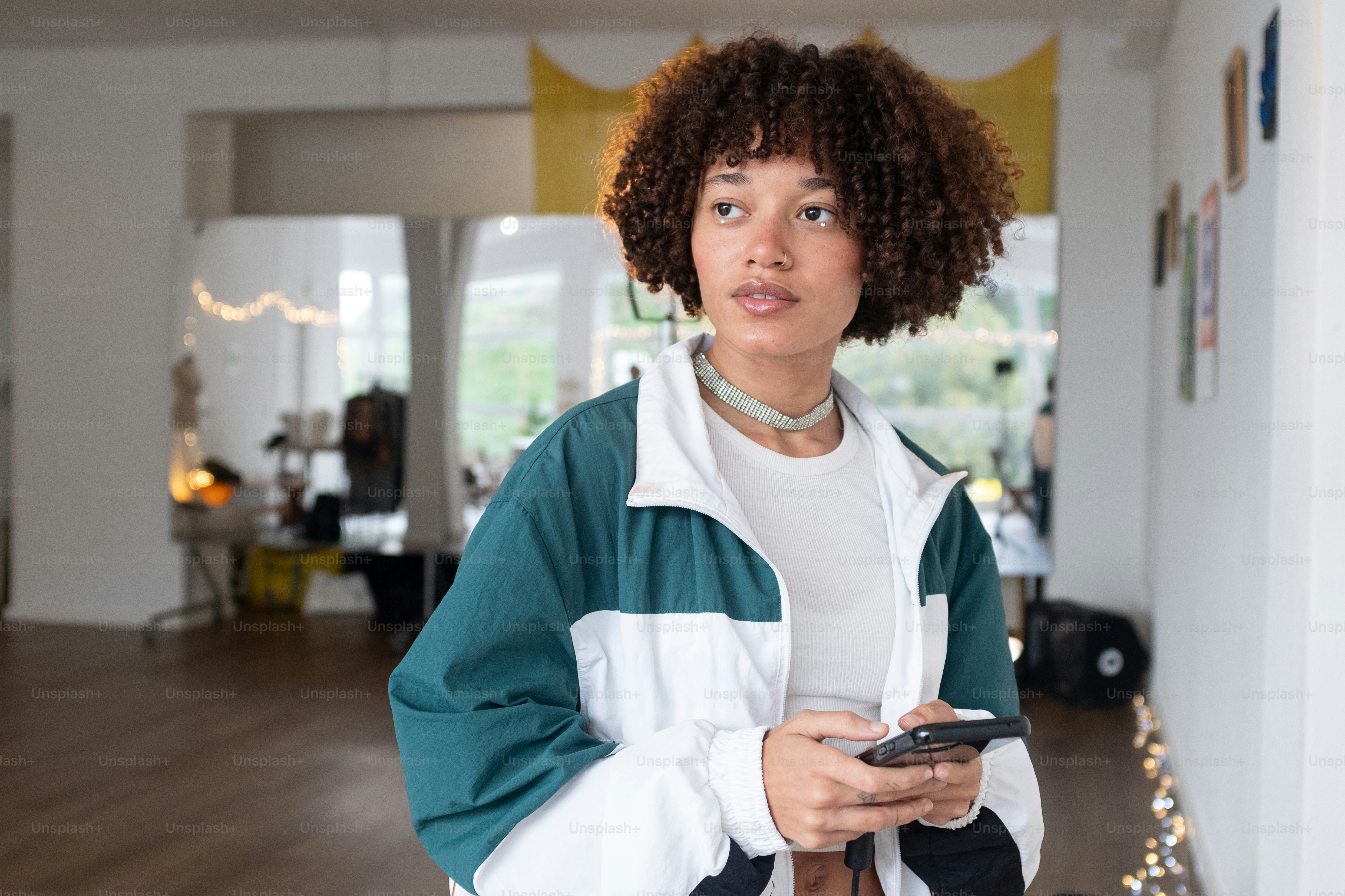 a woman holding a remote control in a room