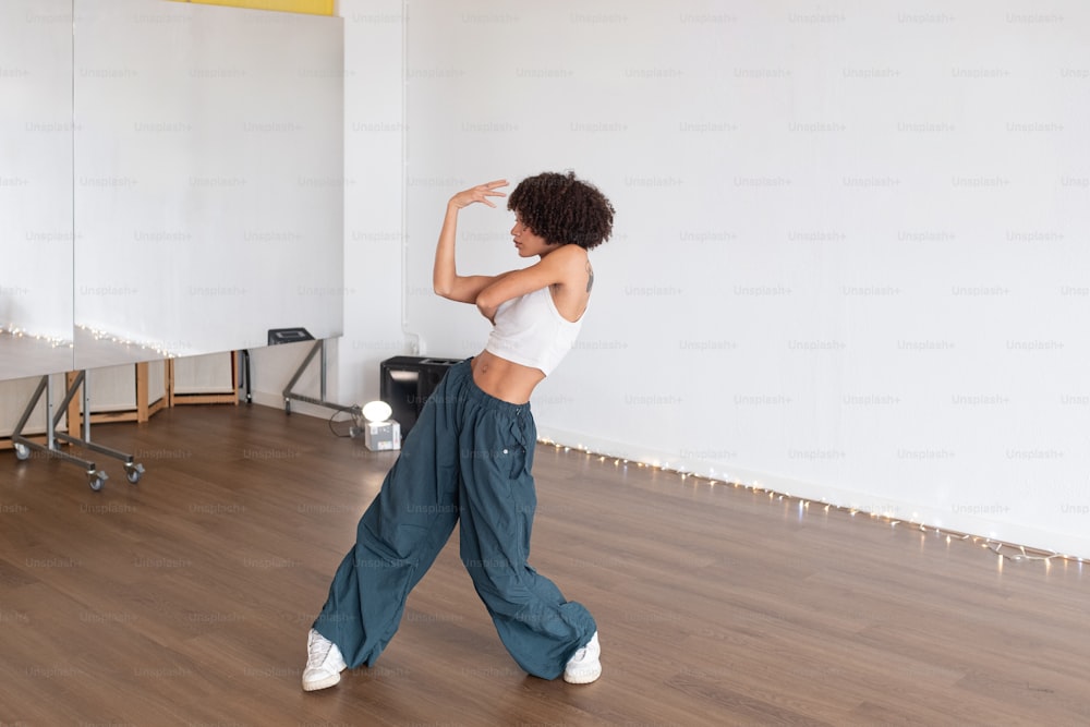 a woman in a white top is dancing