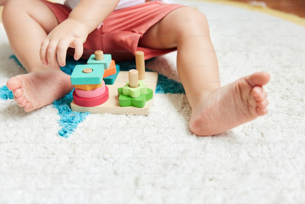 a baby playing with a toy on the floor