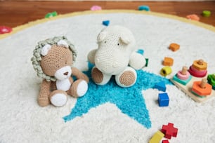 two crocheted teddy bears sitting on a rug