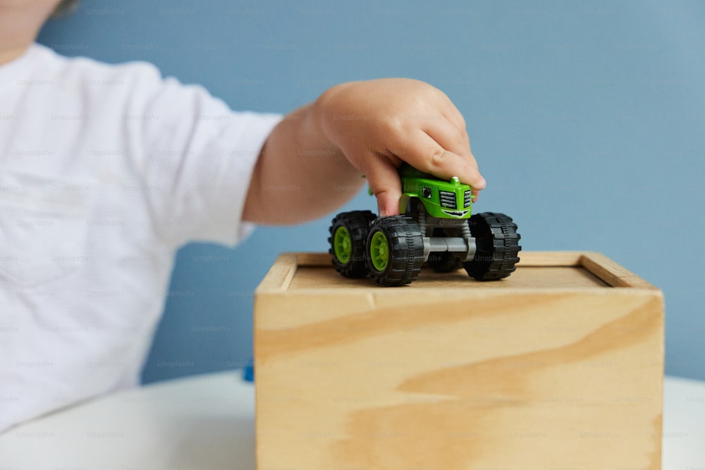 a small child playing with a toy truck