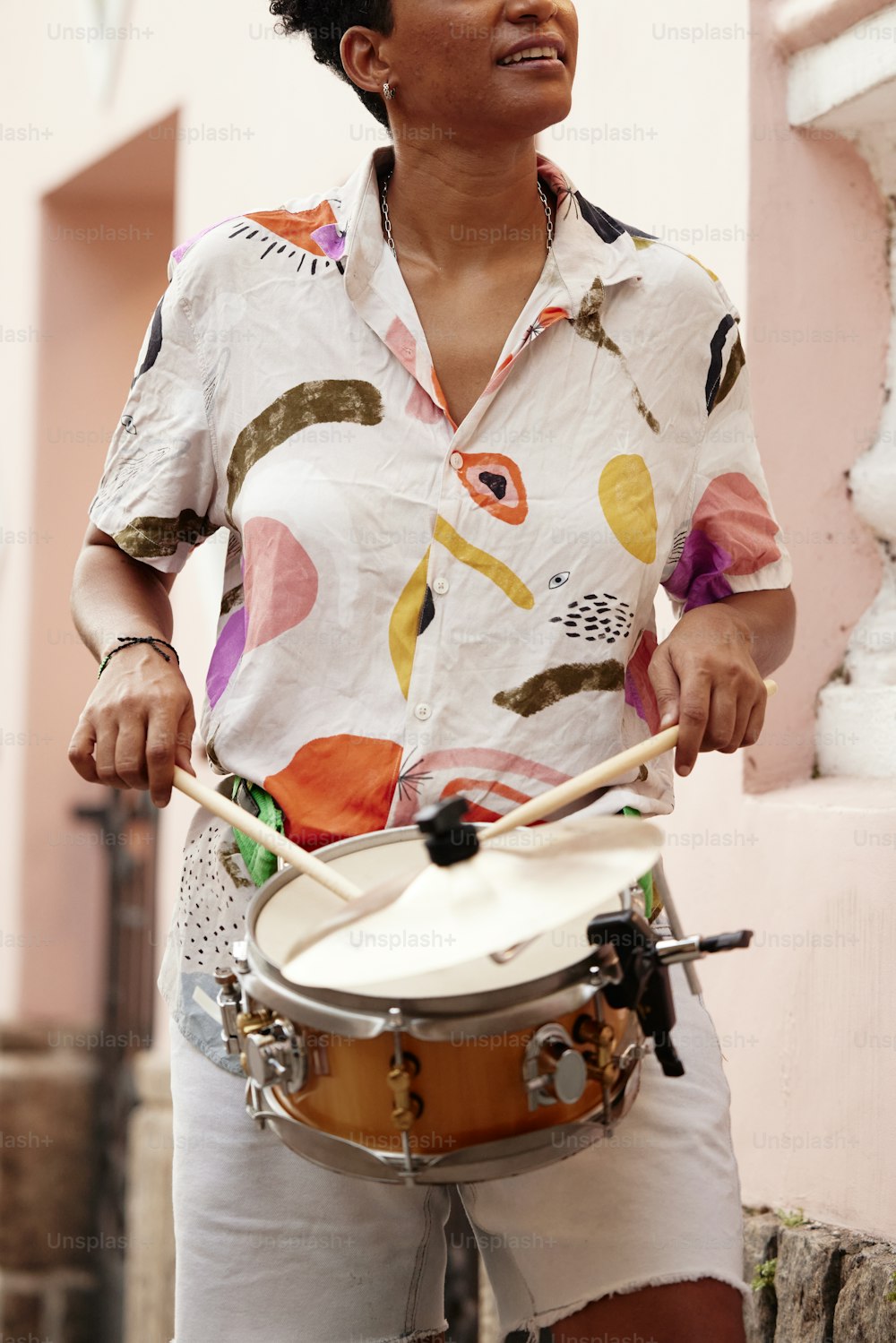 a woman holding a drum in her right hand