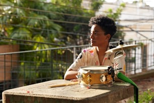 a woman sitting at a table with a pot on top of it