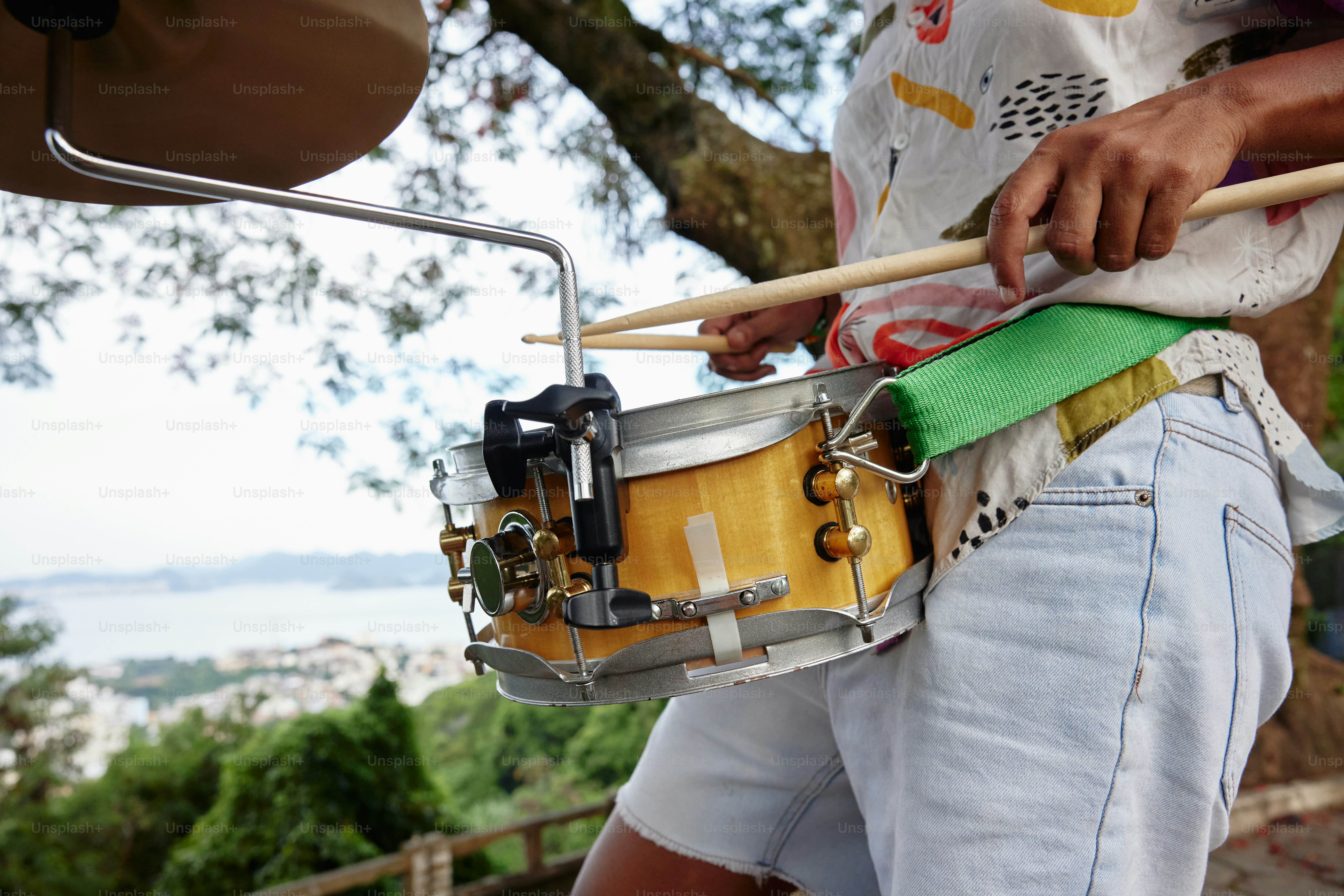 a man holding a drum and a mallet