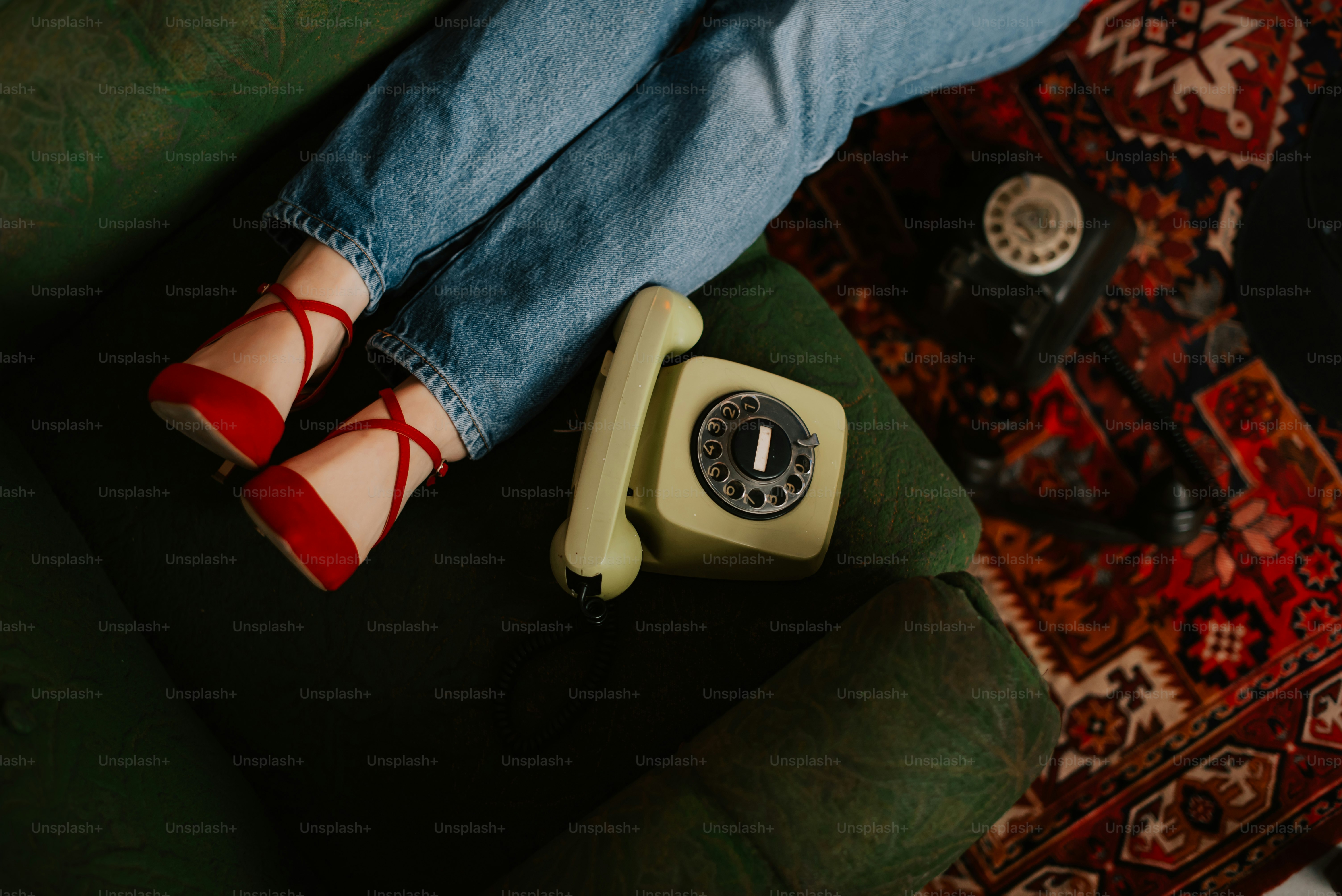 a woman sitting on a couch with a phone in her lap