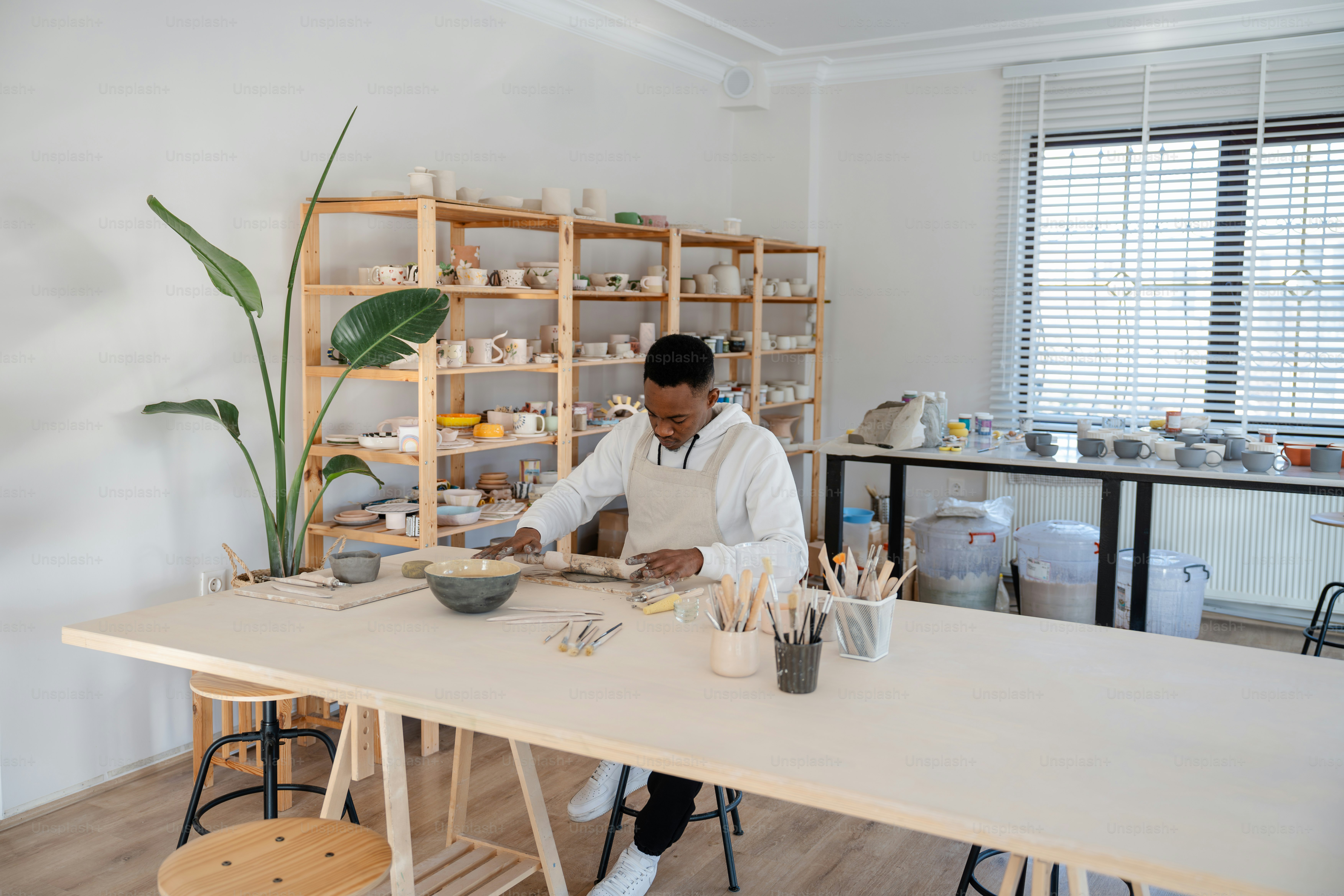 a man working in a pottery shop