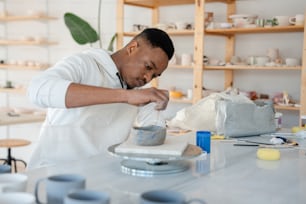 a man in a white shirt is mixing something in a bowl