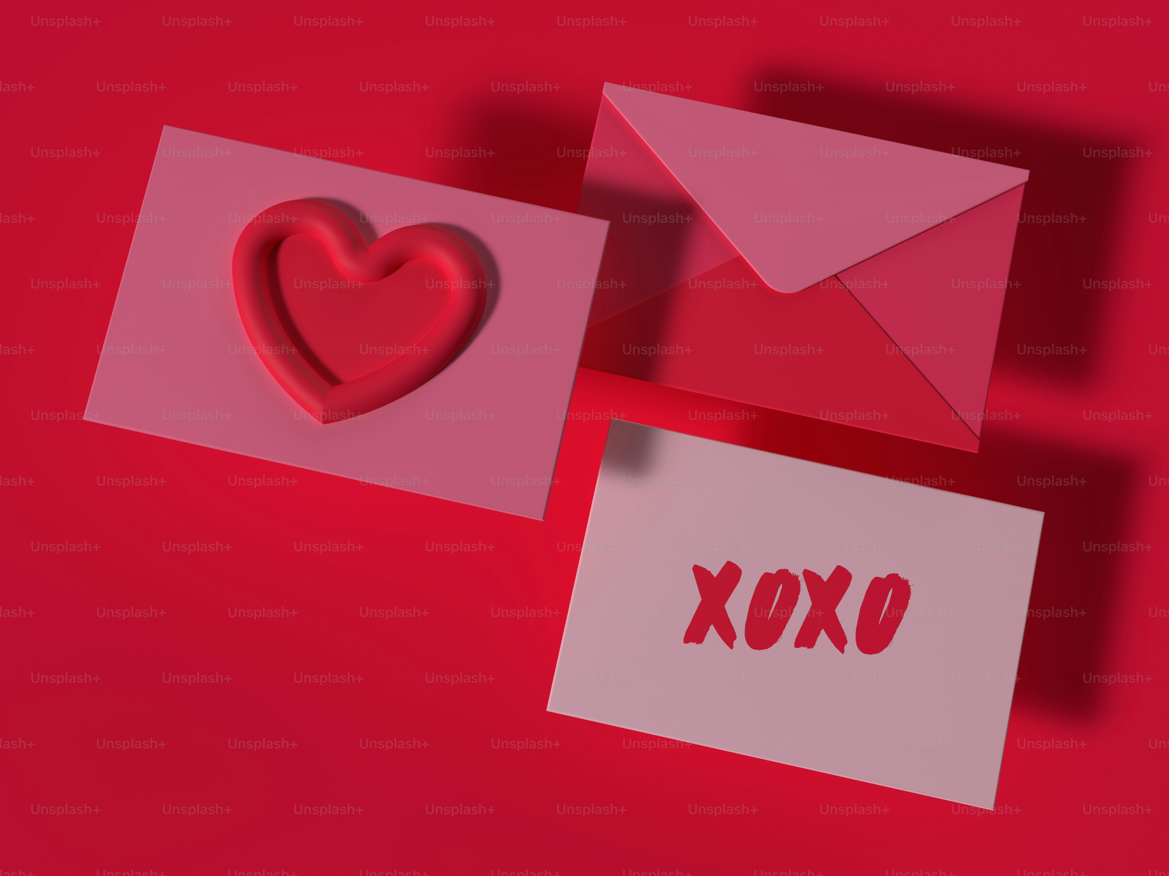 a red envelope with a heart and a card with the word xoxo