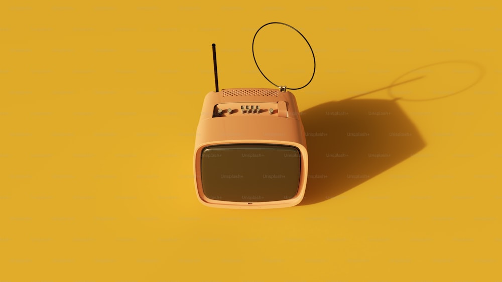 a pink radio sitting on top of a yellow surface