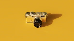 a camera on a yellow surface with a black lens