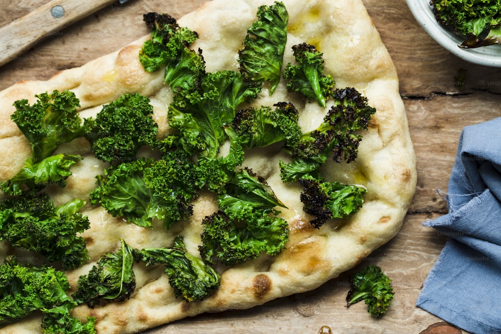 a pizza with broccoli on top of it