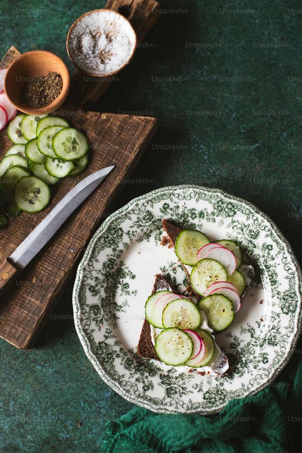 a plate of food with cucumbers and radishes on it