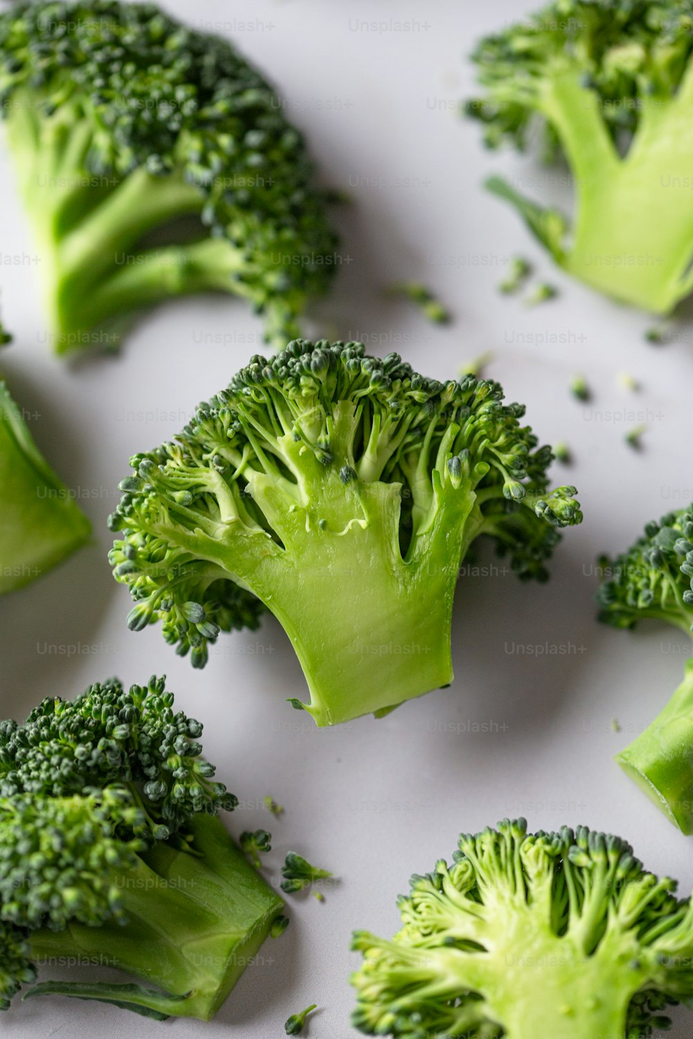 a bunch of broccoli florets on a white surface