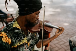 a man in a hawaiian shirt playing a violin