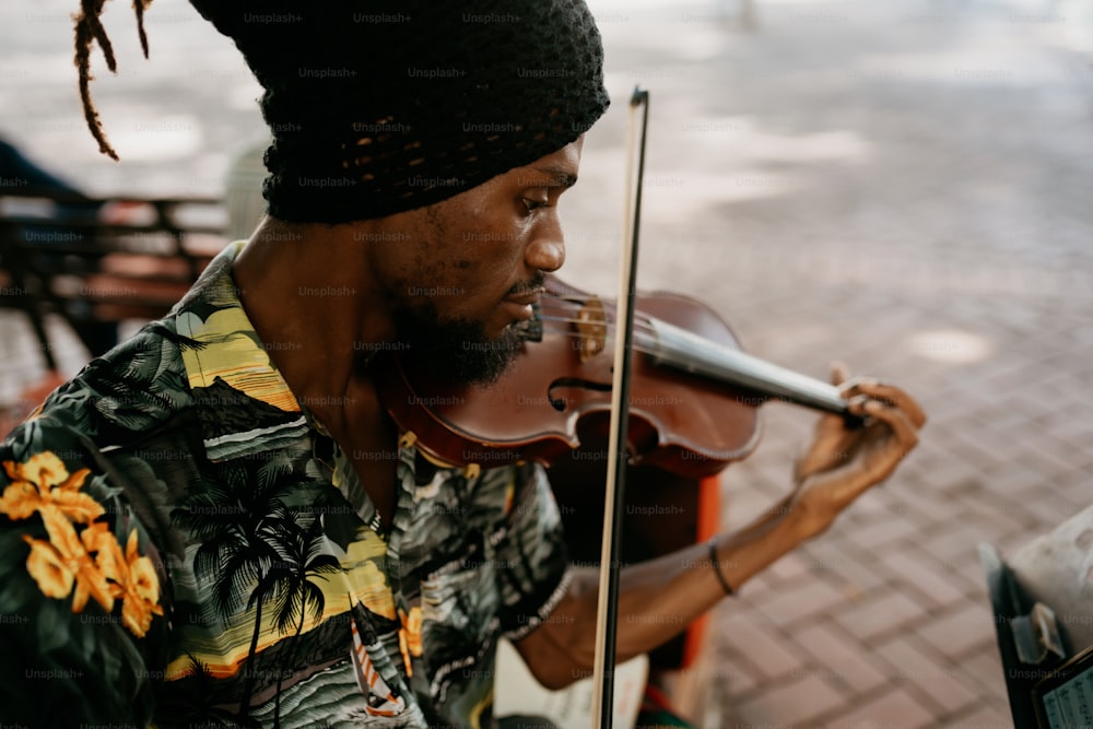 a man in a hawaiian shirt playing a violin