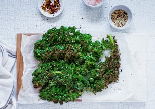 a bunch of broccoli sitting on top of a cutting board