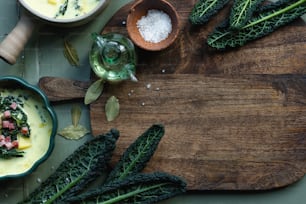 a wooden cutting board topped with green vegetables