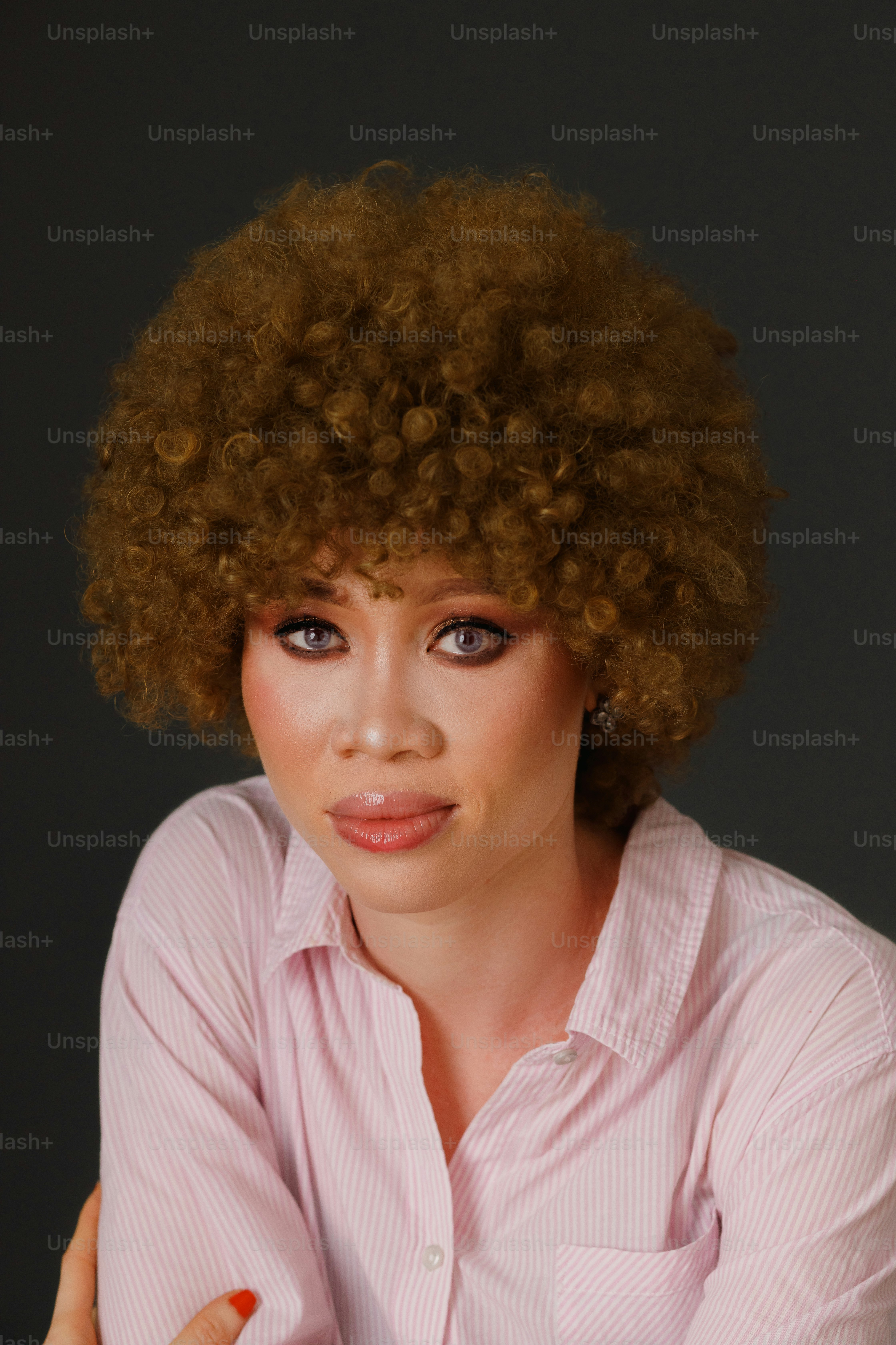 a woman with an afro is posing for a picture