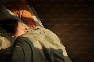a woman laying in bed with her eyes closed