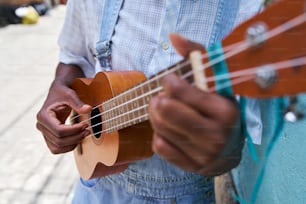 a man is playing a guitar on the street
