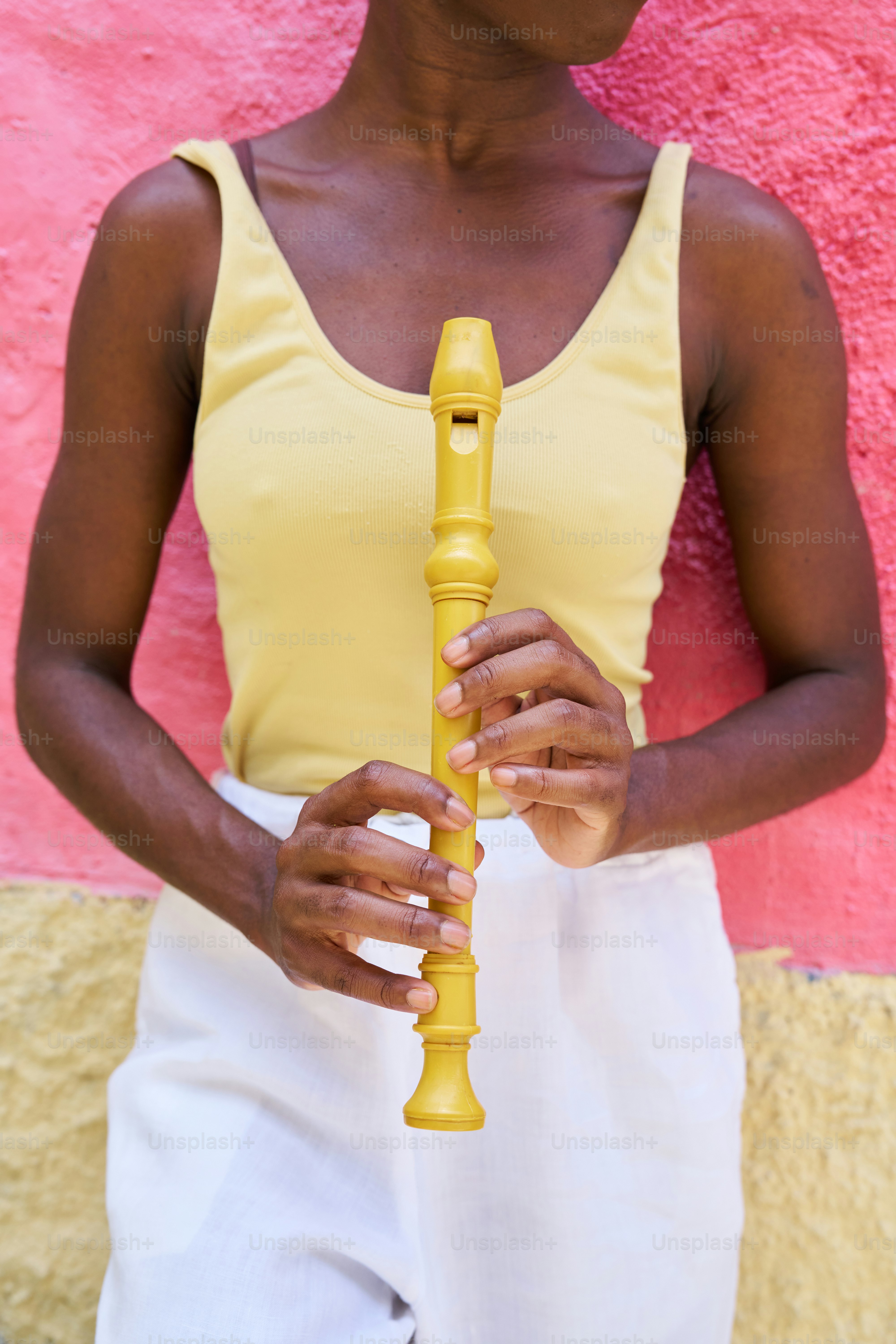 a woman in a yellow top holding a yellow object
