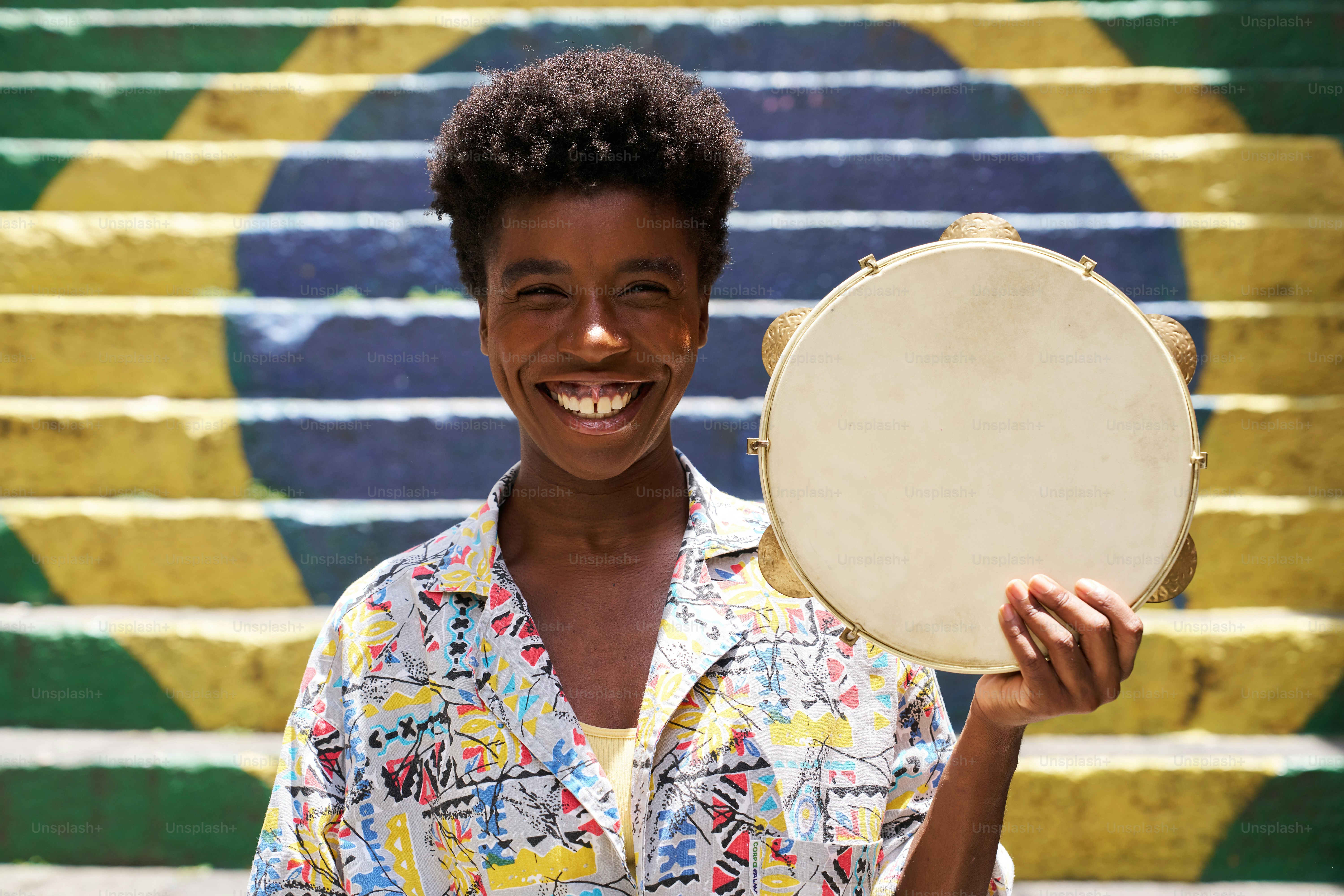 a person holding a drum in front of a wall