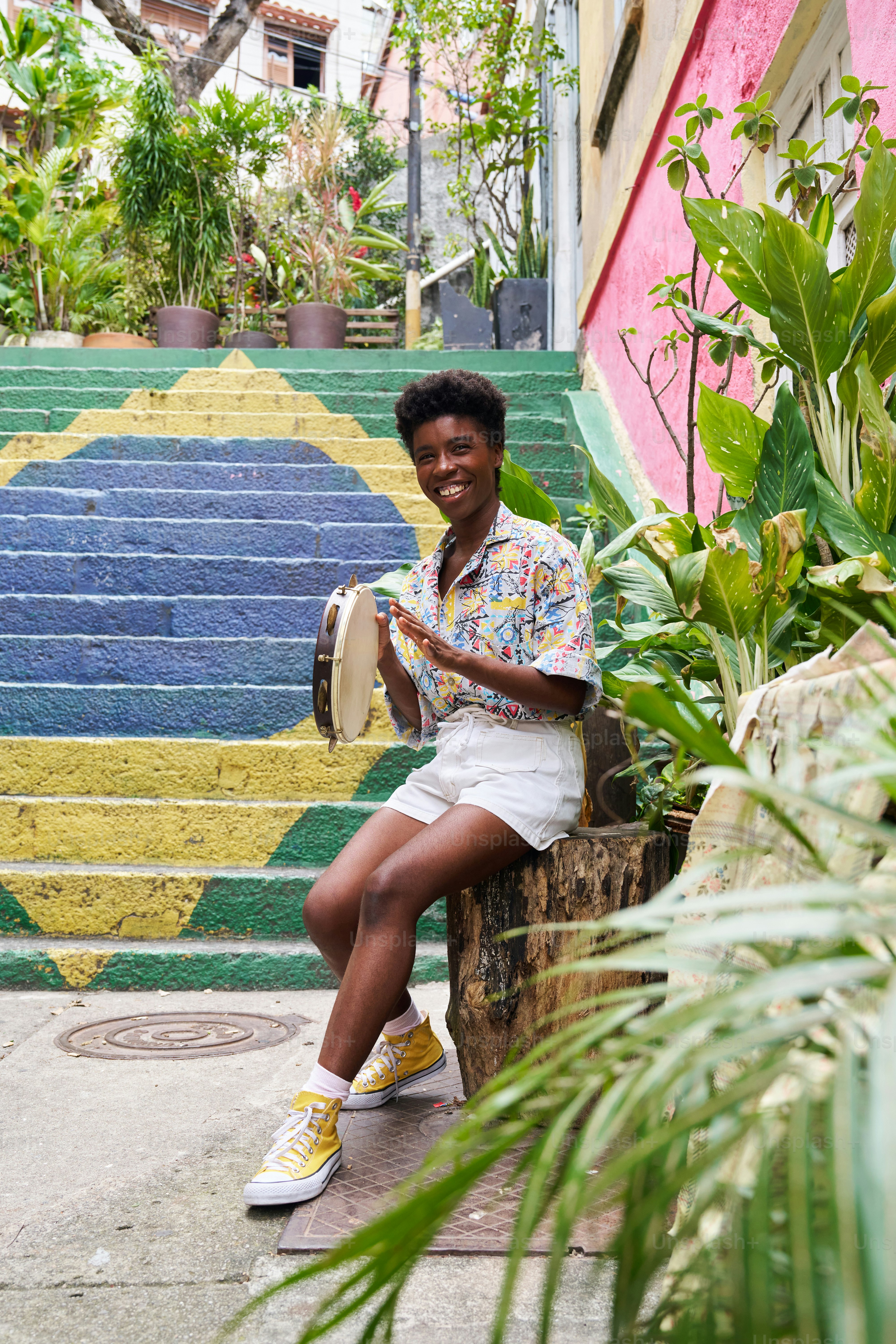 a person sitting on a step with a drum