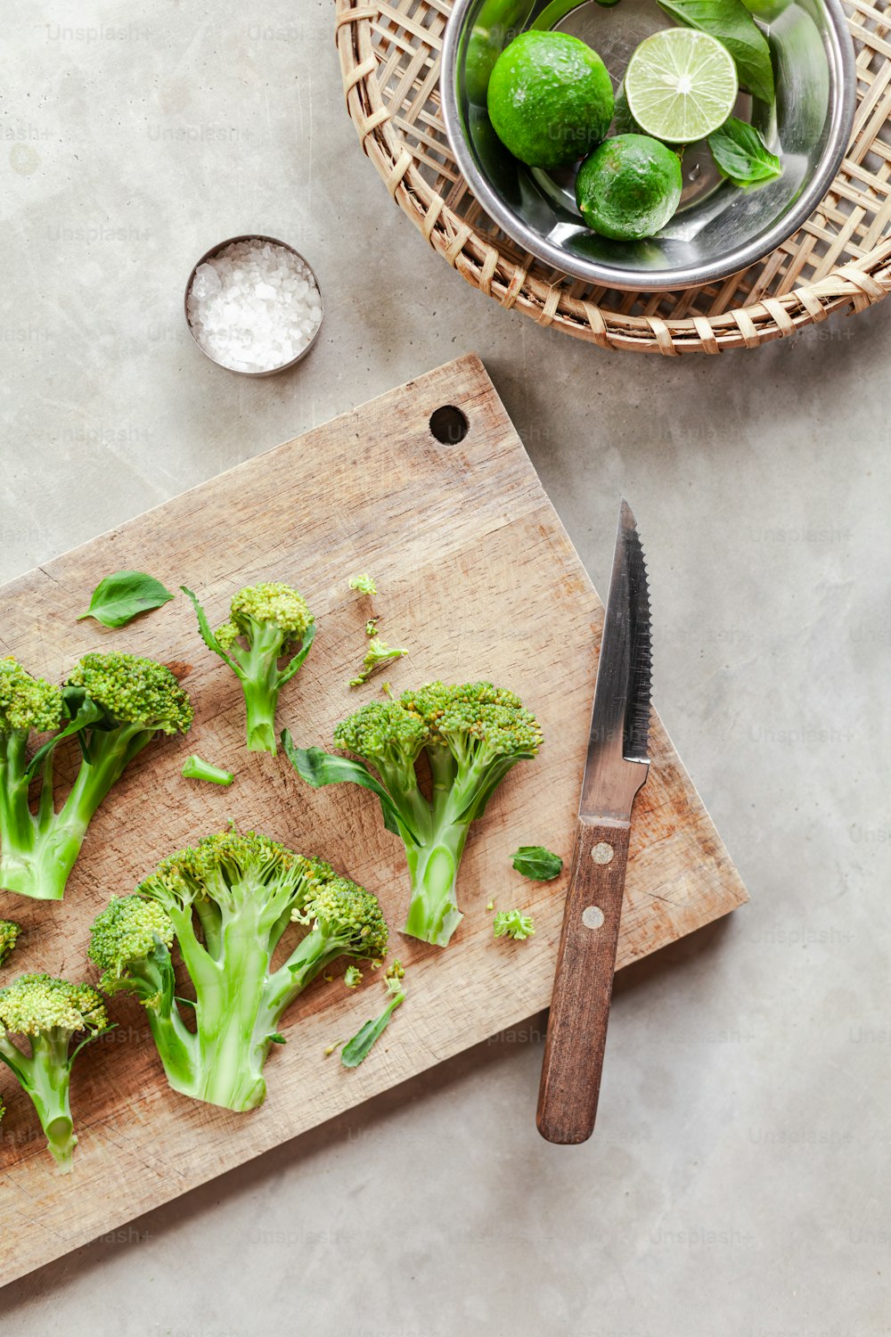 a cutting board topped with broccoli next to a knife