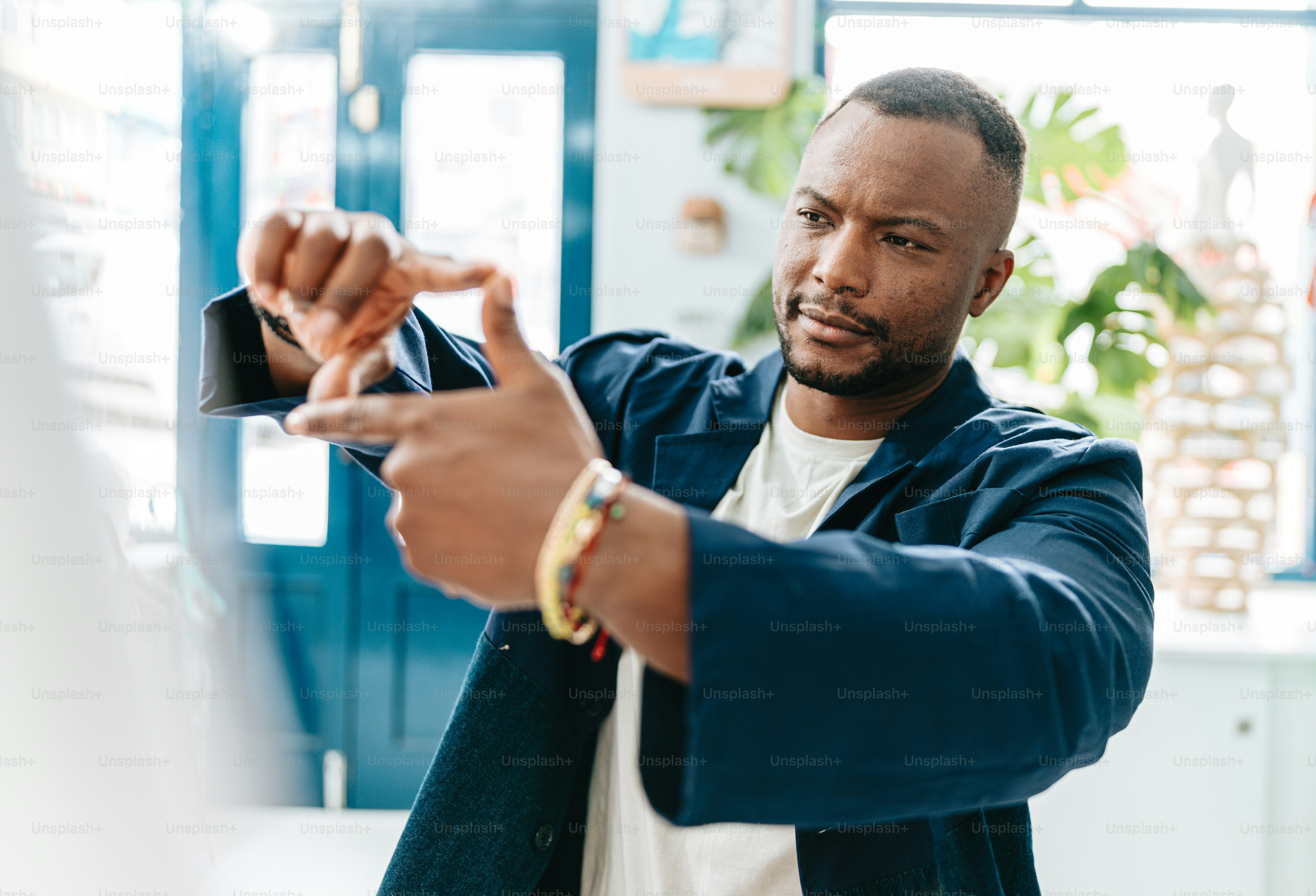 a man in a blue jacket is pointing at something