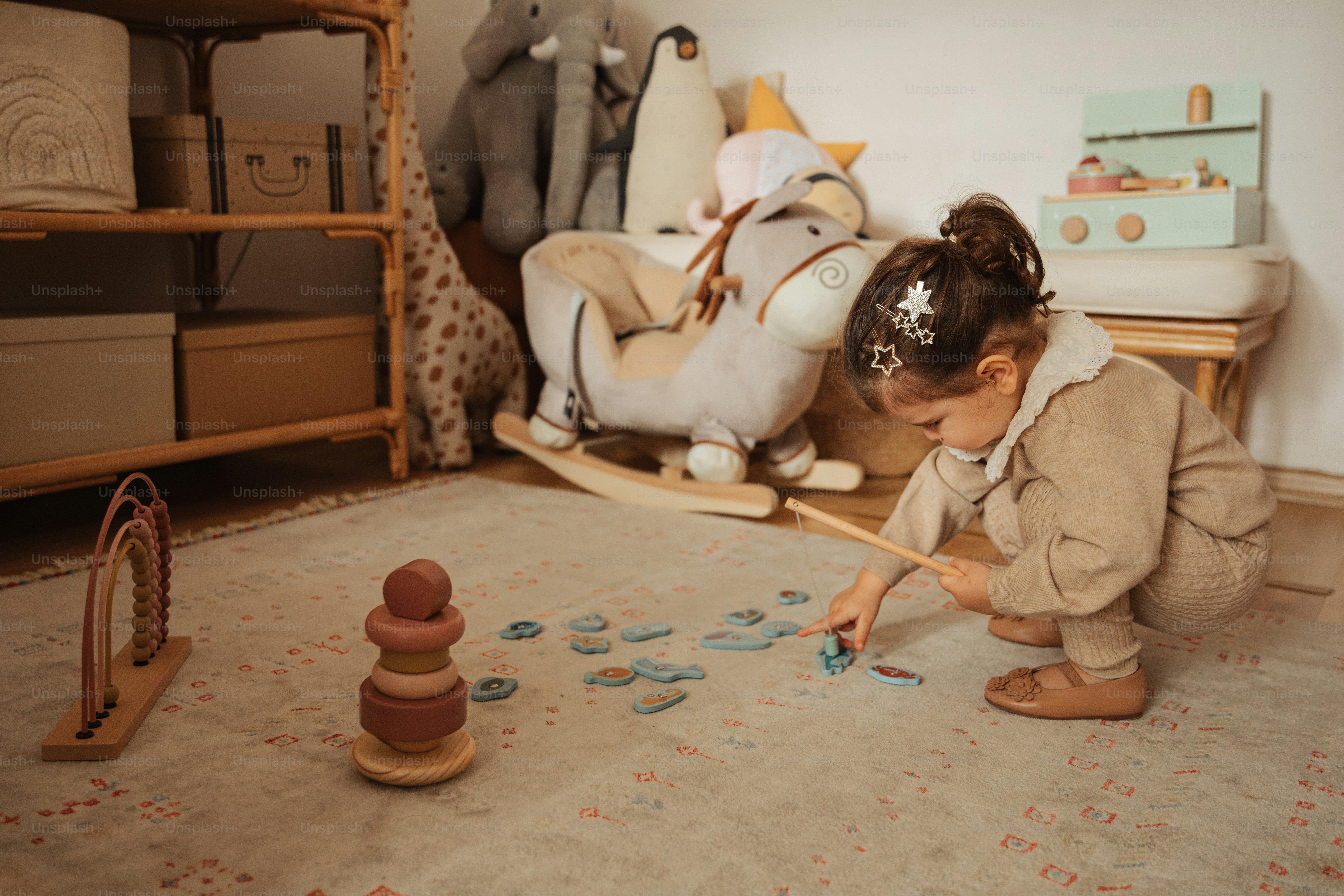 A little girl playing with toys in a room photo – Children Image on ...