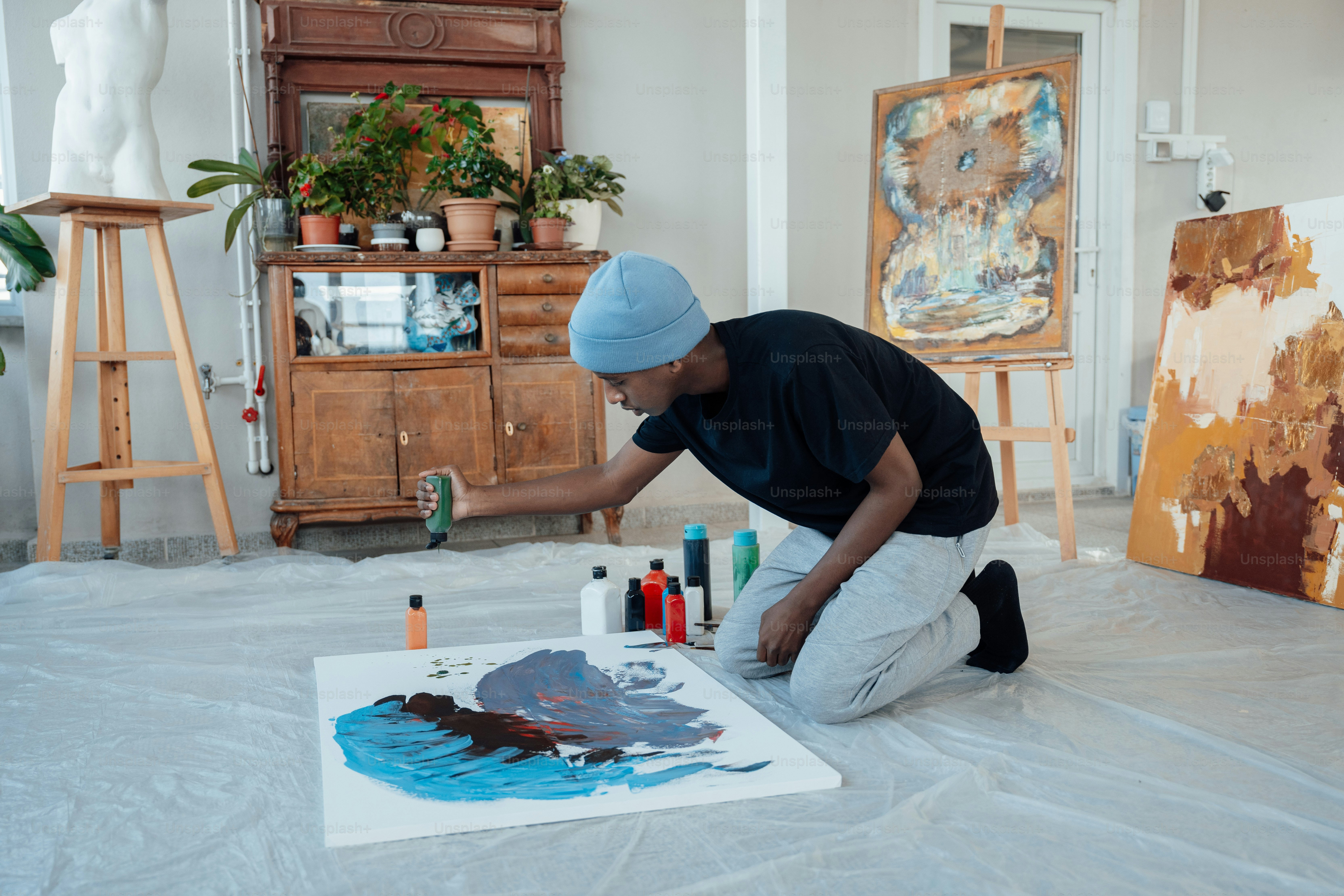 a man is painting a picture on the floor