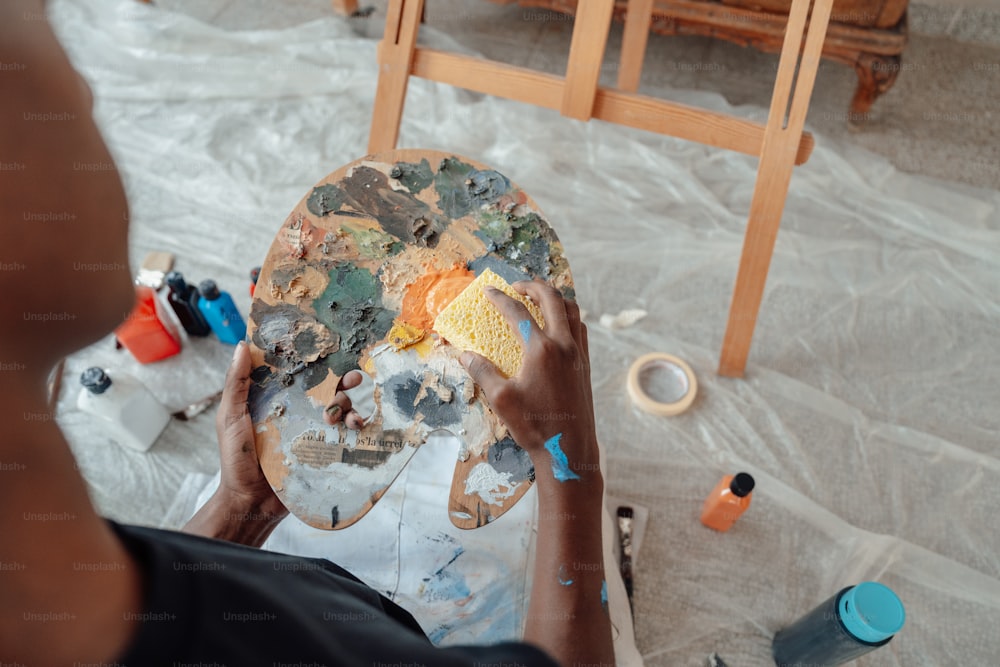 a person is painting a picture on a table