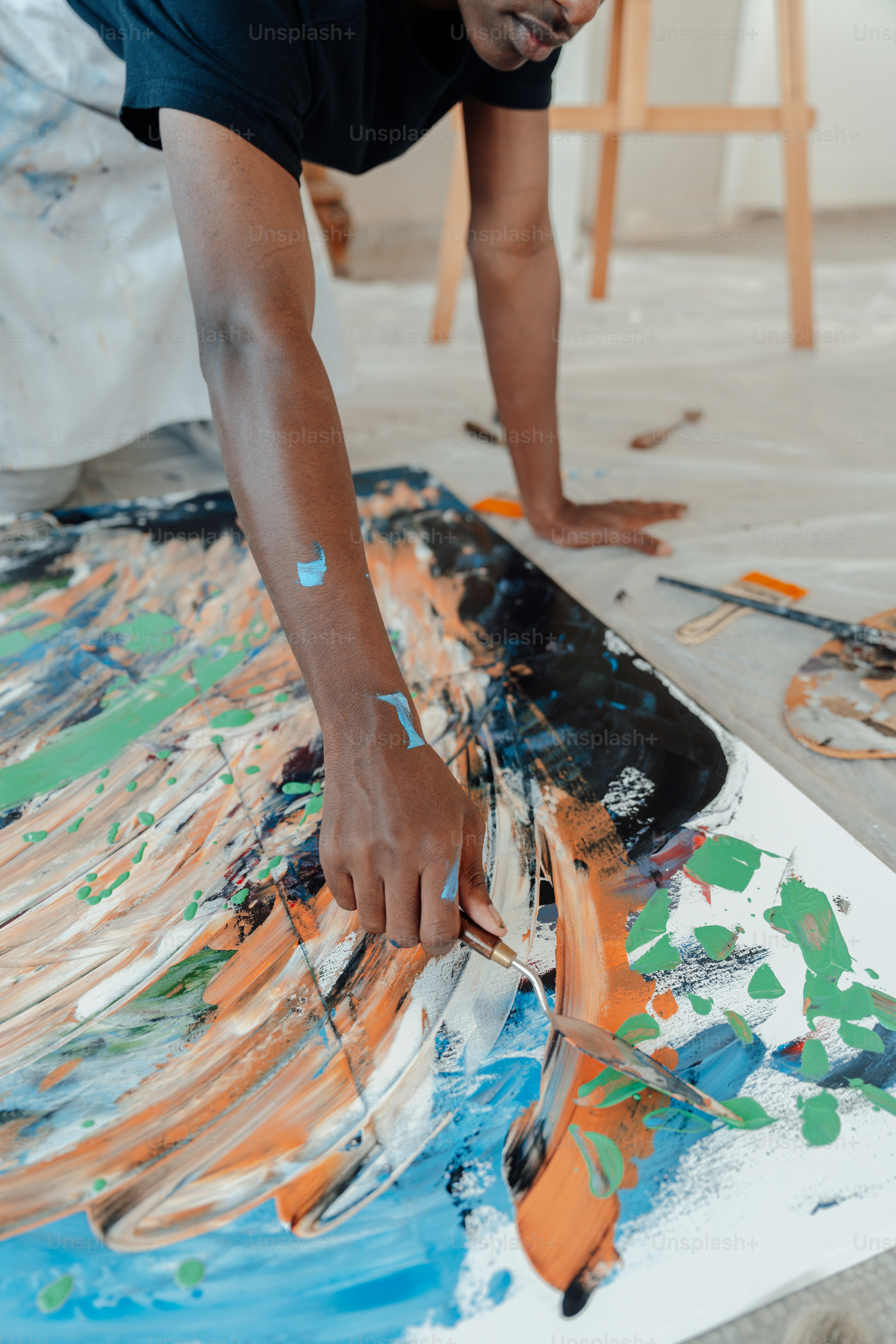 a man is painting a picture on the floor