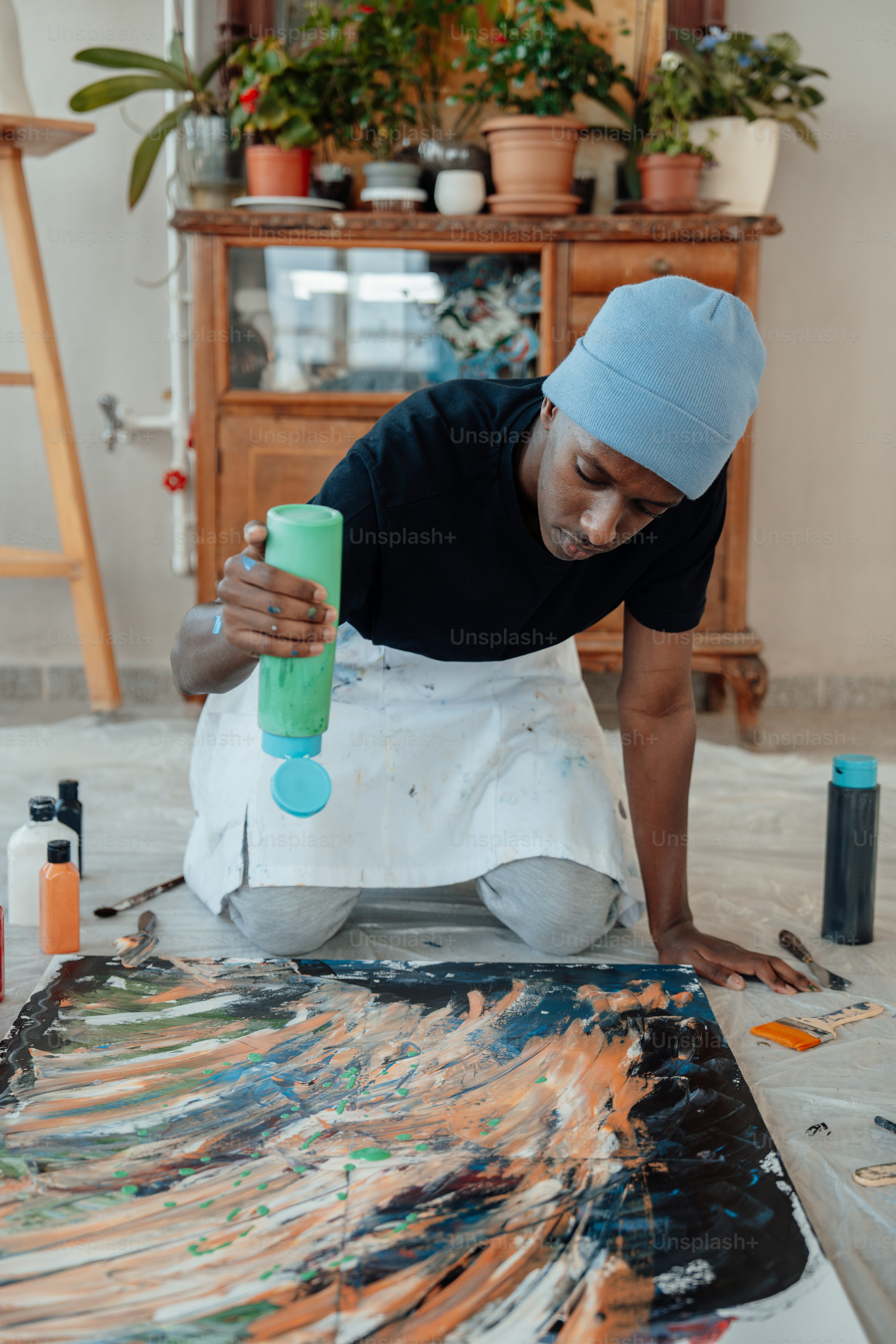 a man is painting a picture on the floor