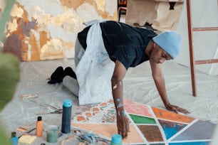 a man is painting a picture on the floor