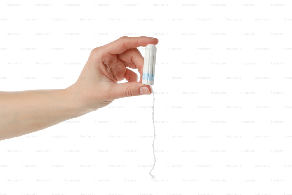 Female hand holding tampon, isolated on white background