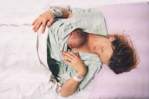 Mother and newborn. Child birth in maternity hospital. Young mom hugging her newborn baby after delivery. Woman giving birth. First moments of baby life after labor.