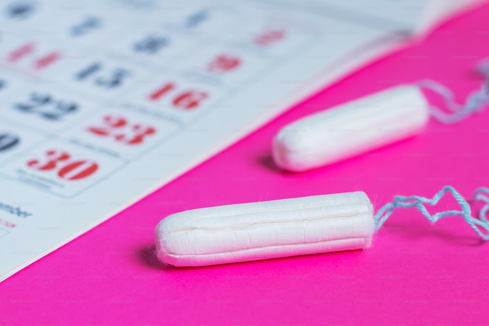 Woman hygiene protection, menstruation calendar and clean cotton tampons