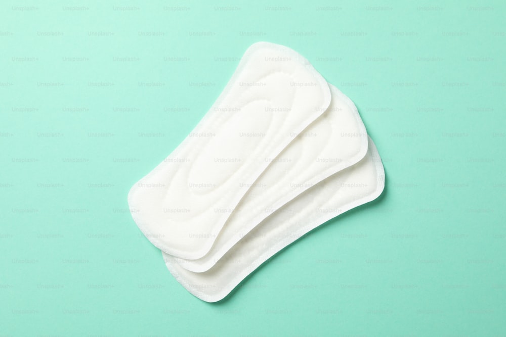 Sanitary pads on mint background, top view