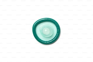 Single mint condom isolated on white background