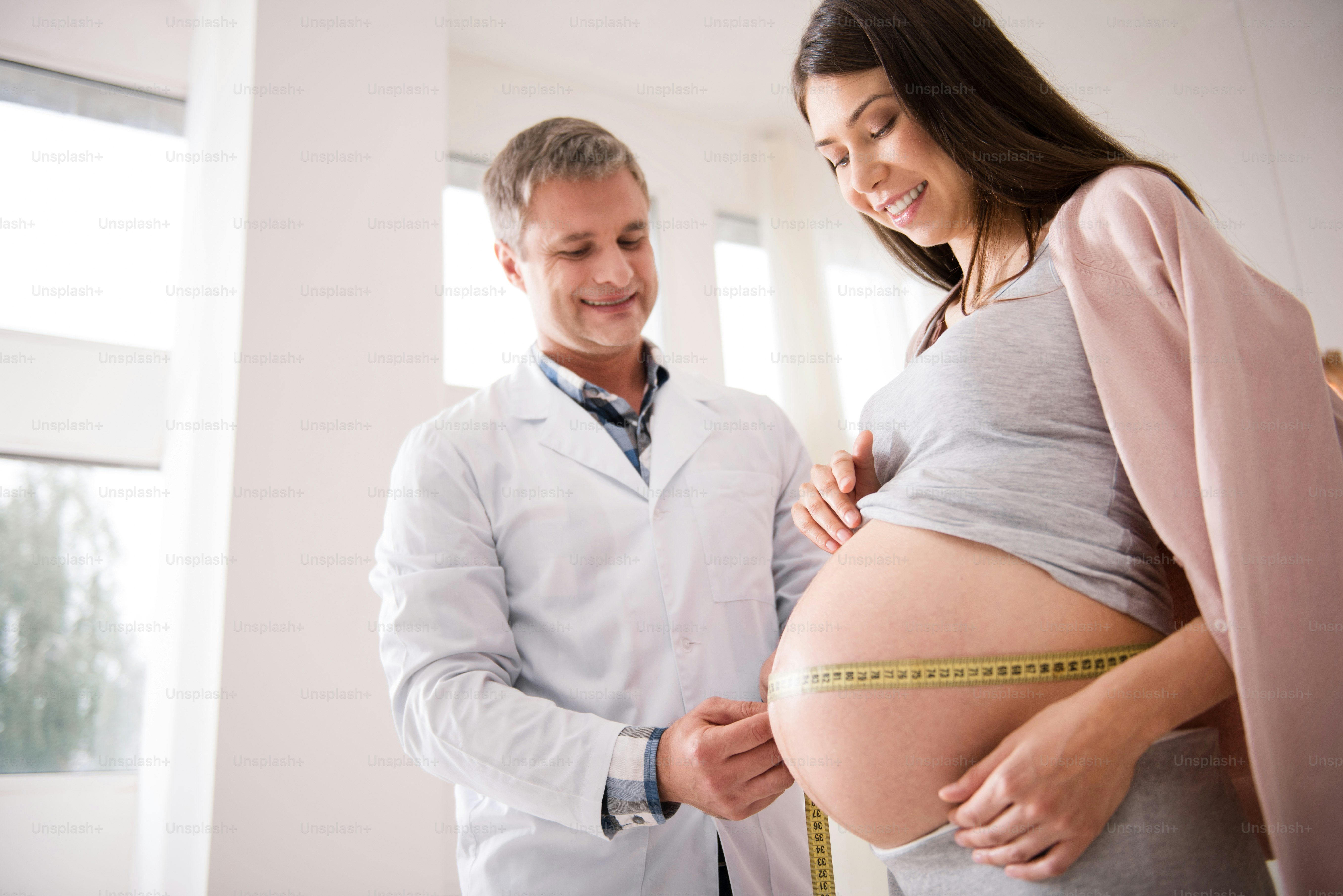 Waiting for you. Charming female person expecting her baby and visiting ...